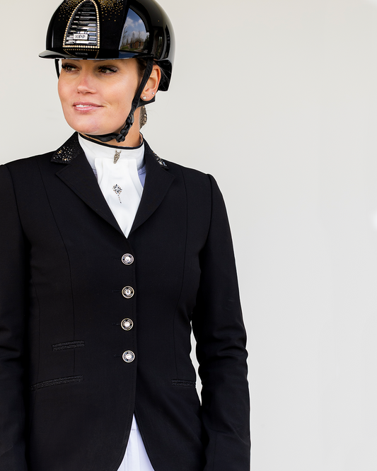 Detail of front of JuulC Women's show jacket in Black Stardust with glitter fabric accents and Swarovski details on the collar, worn by model