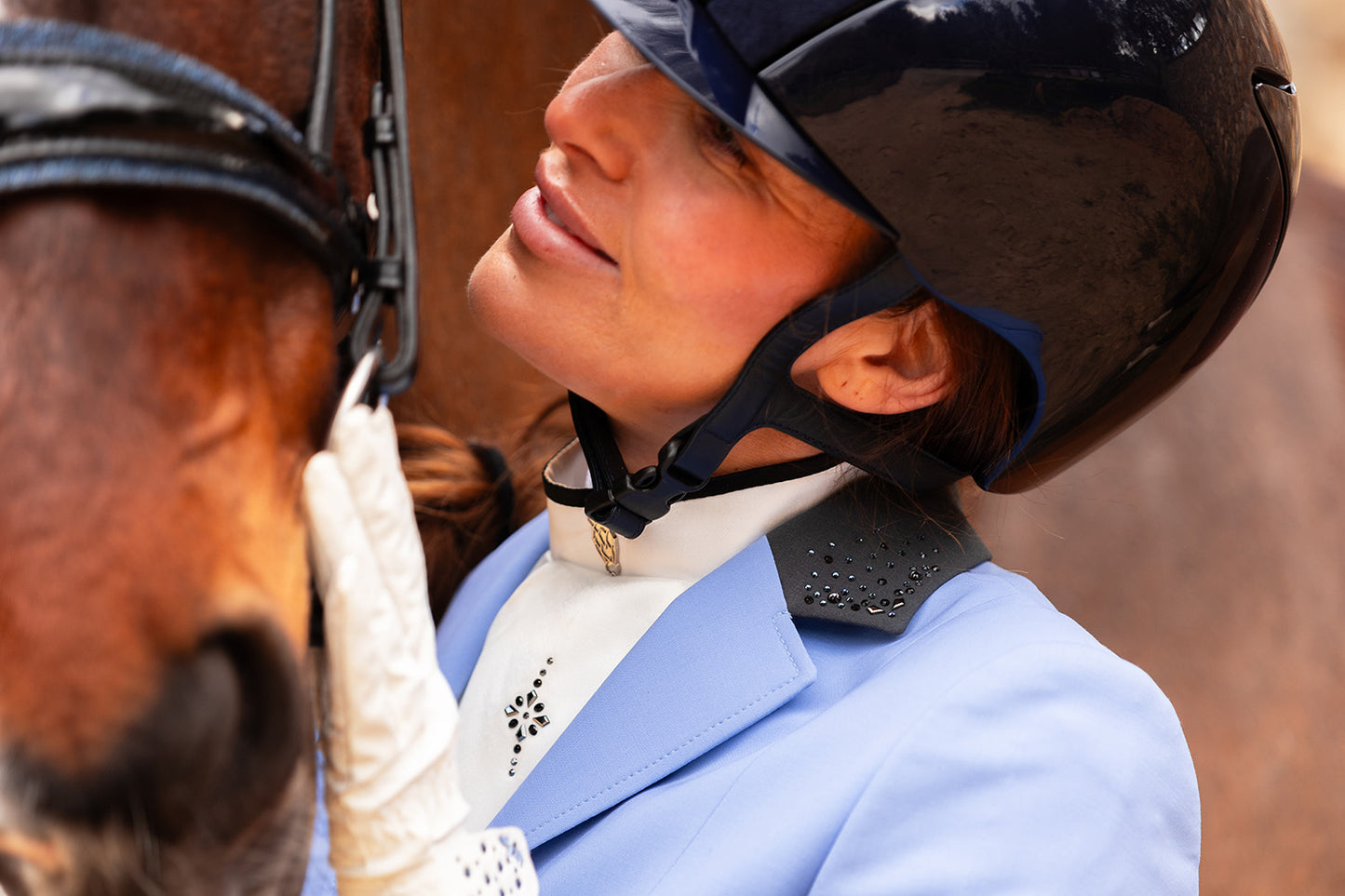 Detail of the top of JuulC Show Jacket in Lavender Blue with grey contrasts and Swarovski details on the collar, worn by model